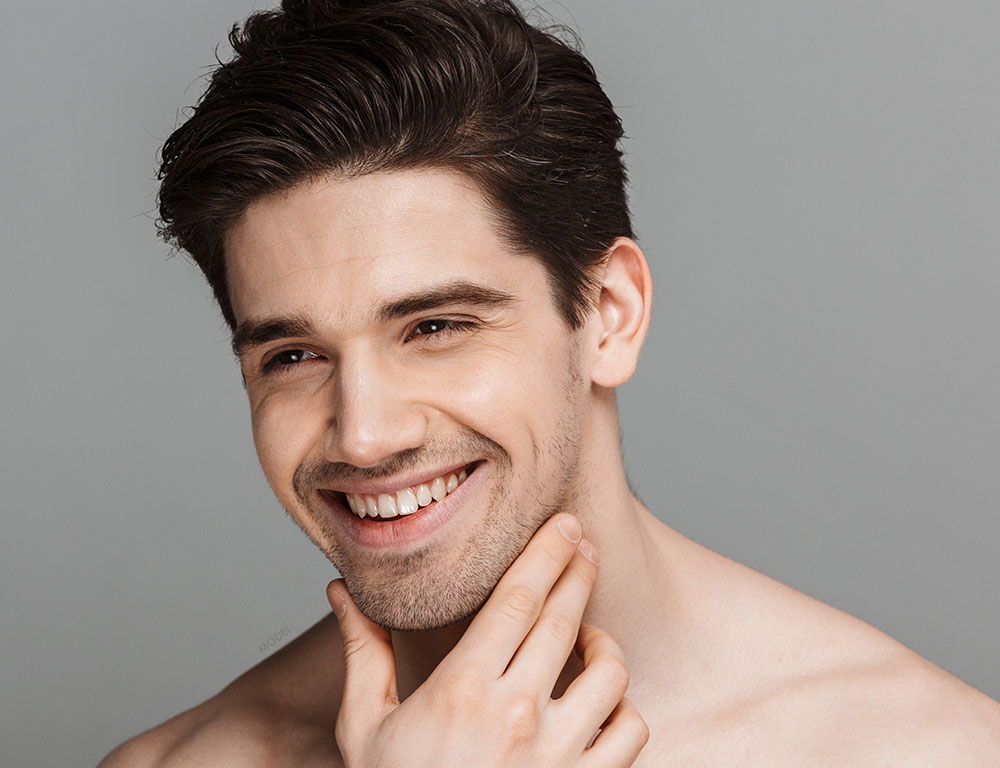 Young man touching his chin